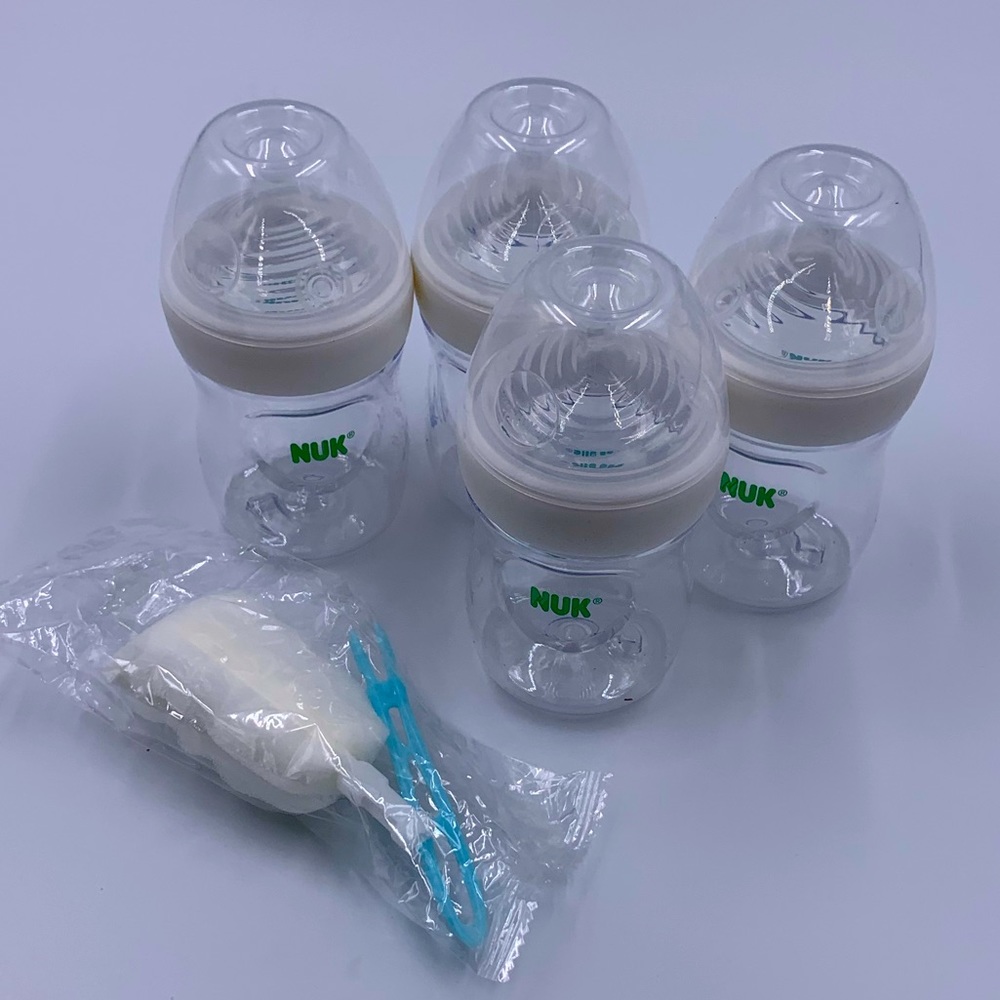 NEW IN THE ORIG BOX..NUK simply natural baby bottle with safe temp..5oz, 4 count